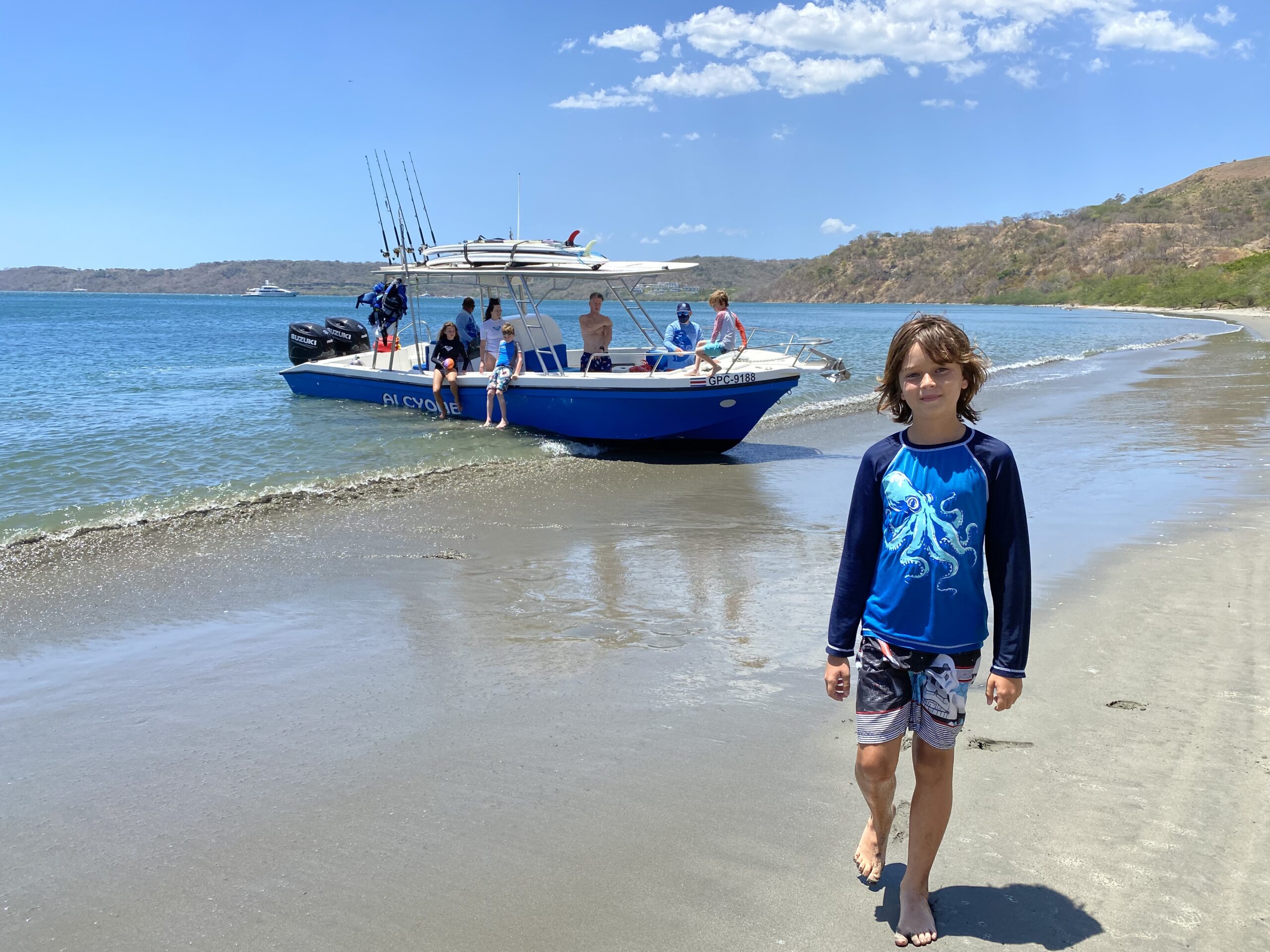 Family arriving by private boat at Playa Huevos in Peninsula Papagayo, Costa Rica.