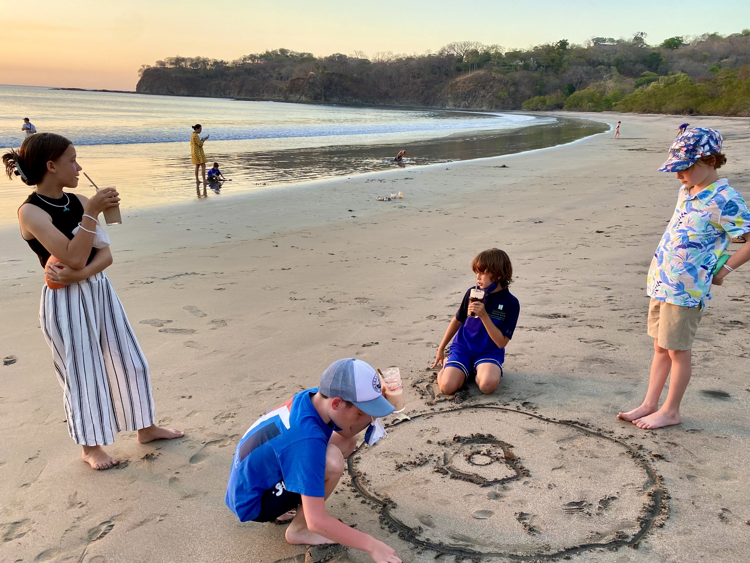 Families enjoying sunset on Prieta Beach in Peninsula Papagayo