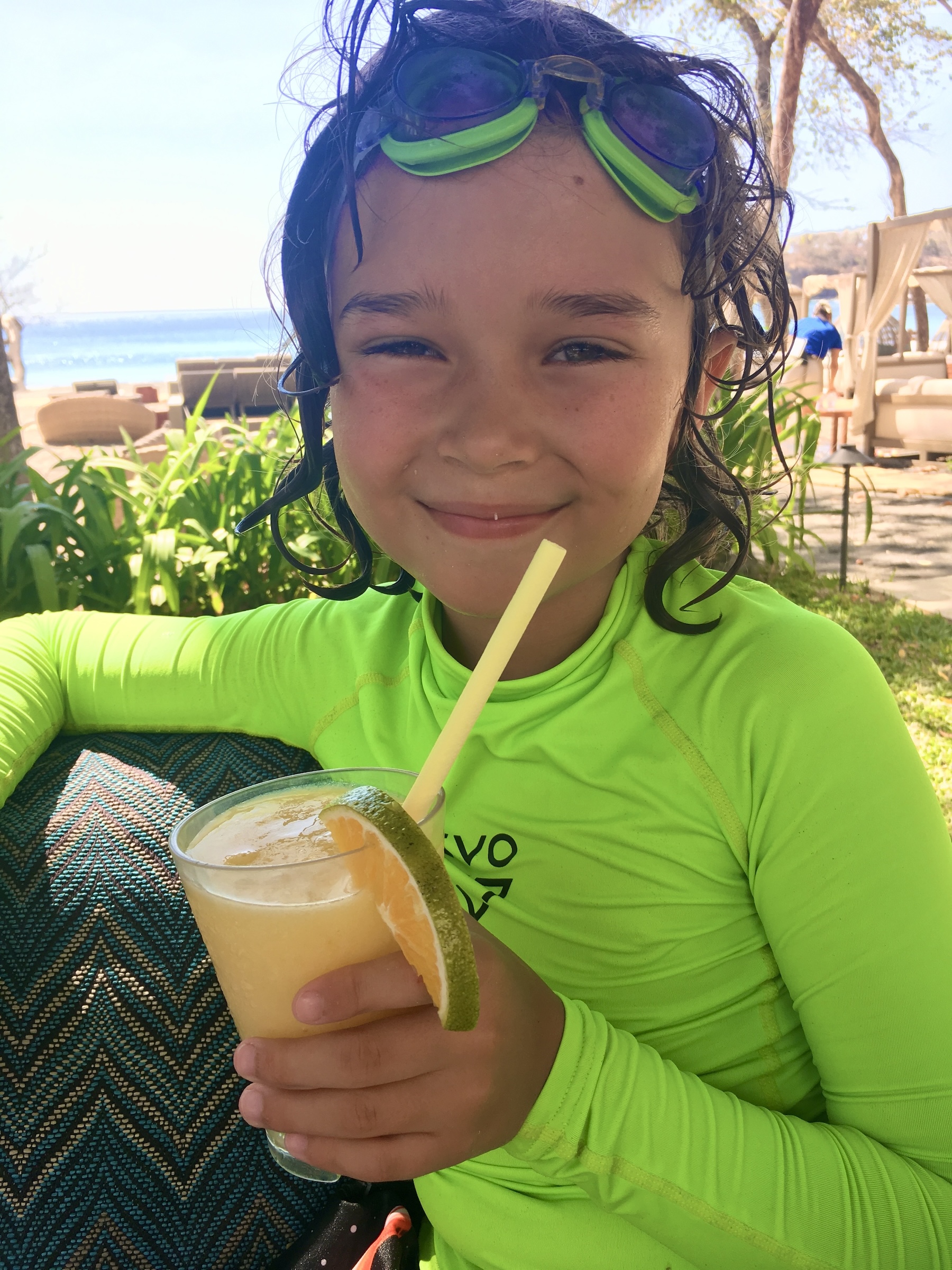 Child enjoying a tropical drink at Prieta Beach Club