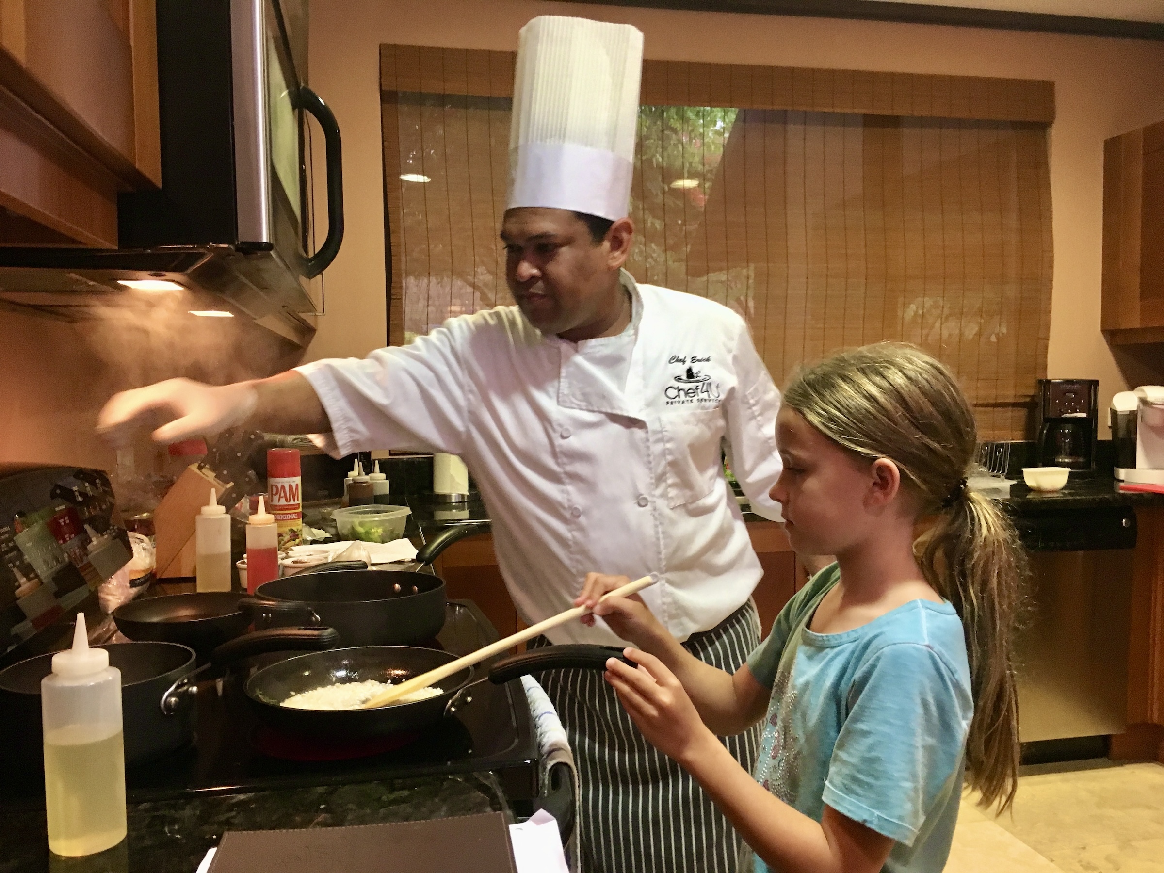 Private chef cooking with a young guest during an in-villa dining experience in Peninsula Papagayo, Costa Rica.