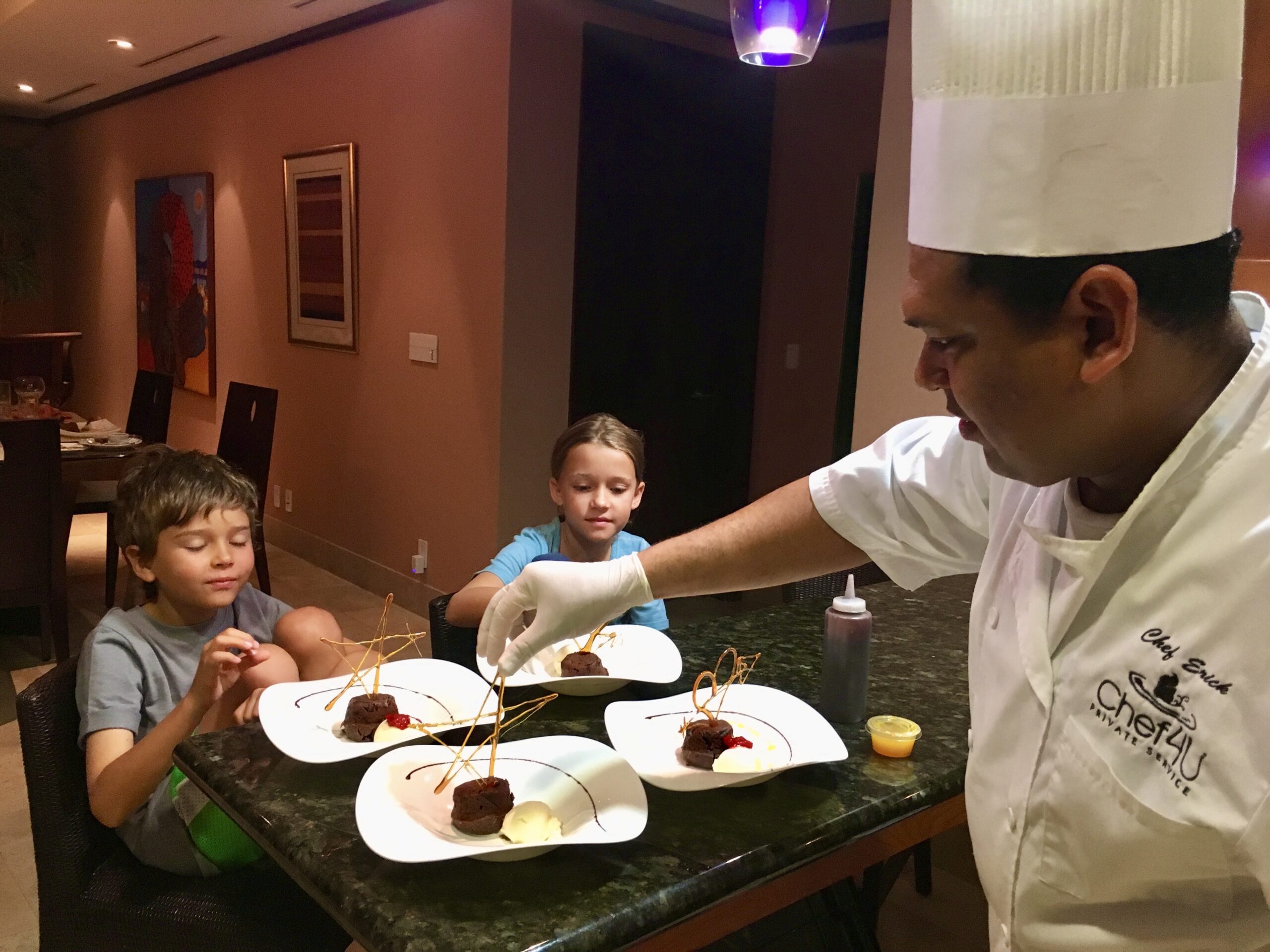 Private chef serving dessert to children during a family vacation in a luxury Peninsula Papagayo villa