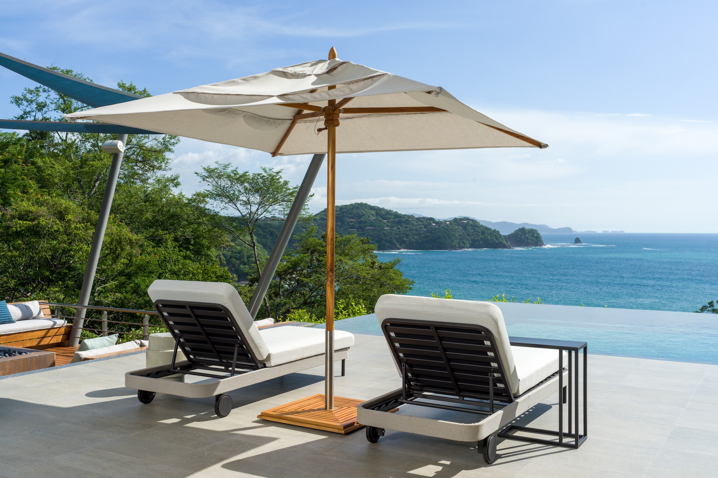 Poolside lounge chairs overlooking the Pacific Ocean at Sky’s Edge