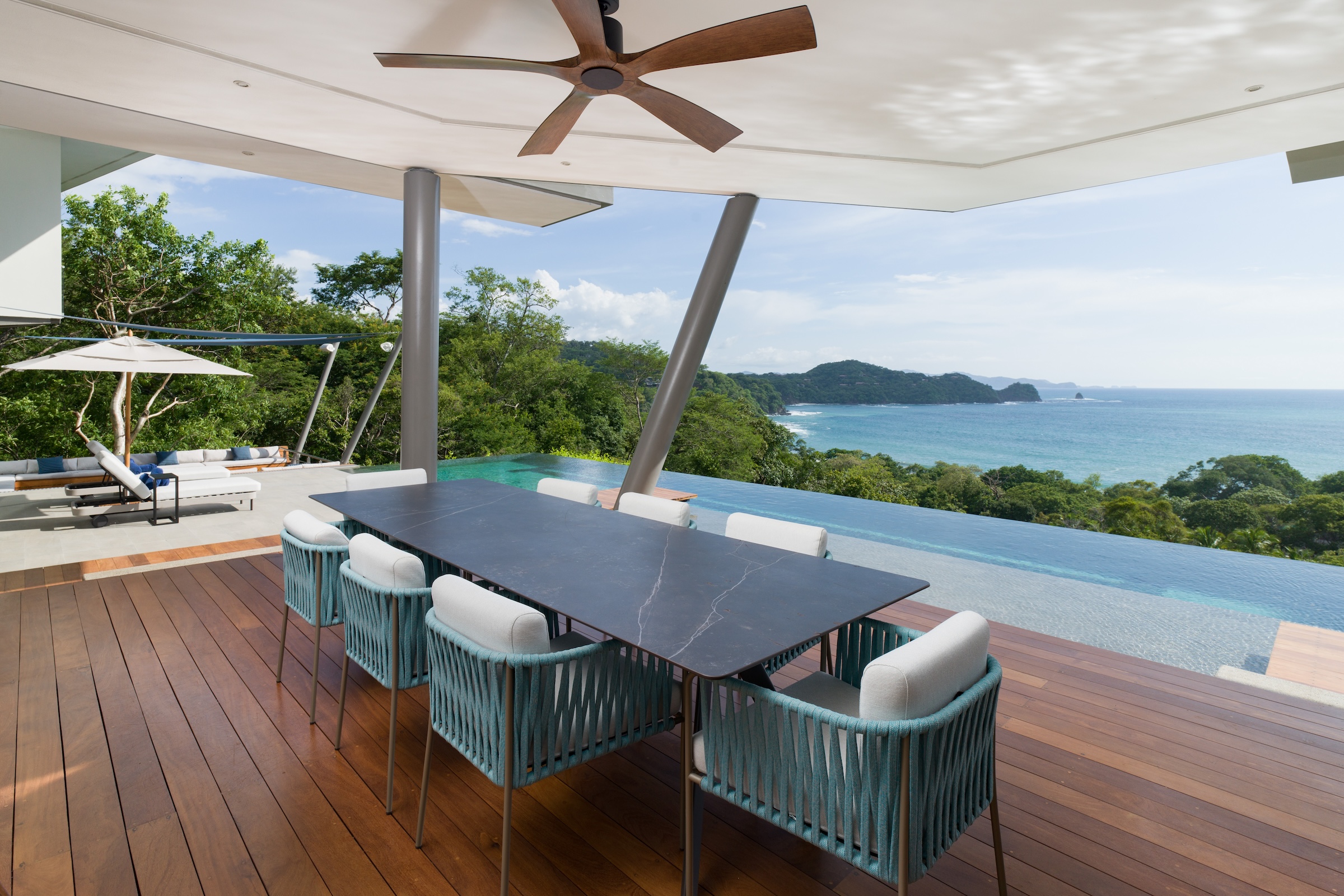 Covered outdoor dining terrace with Pacific Ocean views at Sky’s Edge